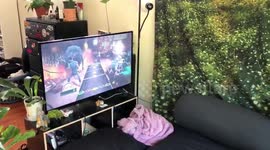 Man plays guitar hero on a trampoline in the backyard