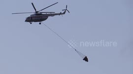 Helicopter MI-8 is carrying 5 tones of water to extinguish fire in St Petersburg (Russia)