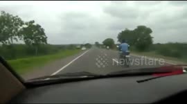 Terrifying moment dangerously riding biker crashes into SUV