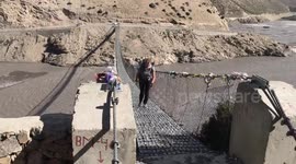 Nerve-wracking moment UK couple cross windy bridge in Nepal