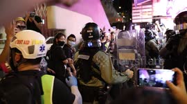 Hong Kong Police move in to make an arrest because a young boy shouted profanities at police