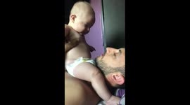 Hilarious moment baby throws up in dad's eye while playing at their UK home