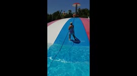 Woman hilariously falls off inflatable into pool of water