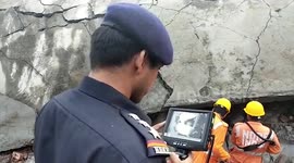 Rescue personnel uses special cameras to look for survivors after Indian factory explosion