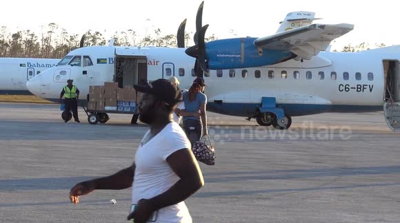 Injured old man assisted to evacuation airplane at Treasure Cay Airport Abaco after Hurricane Dorian