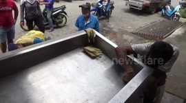 Butcher rescued after getting his finger stuck in blocked sink in south Thailand