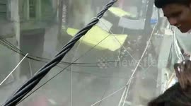 Two storey-building collapses burying several vehicles under its debris in northern India