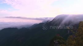 Stunning drone footage showcases 'sea of clouds' flowing down Mount Lu in China
