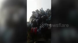 School students cling precariously to moving bus in northern India; police confiscate vehicle after video surfaces