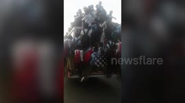 School students cling precariously to moving bus in northern India
