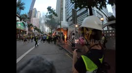 Journalists rush to the scene as a fire is started by protesters before Wanchai MTR station