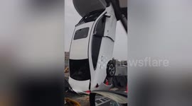 Car stuck upright after smashing into road signpost on Chinese road