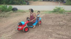 Grandmother Rides On Boy's Toy Truck