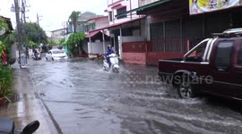 Drivers battle through flooded roads after heavy rain in northern Thailand