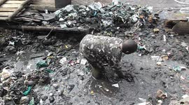 Man in Kenya sifts through knee-deep waste to clear out plastic