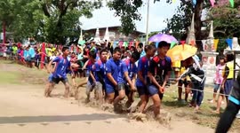 Bizarre race in Thailand where boys make a human boat and run through muddy field