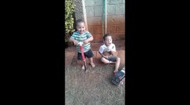 Toddlers making farting sounds with a tire pump