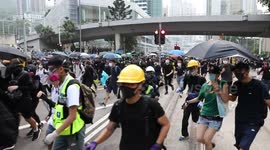 Moment Hong Kong protesters run for cover as police fire tear gas