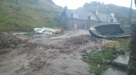 Torrents of water gush through Scottish village in flash floods