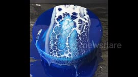 Oddly satisfying swirling mirror-glazed cake created by German chef