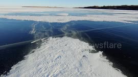 Nervous pet dogs refuse to walk across frozen lake but stay on the parts covered with snow