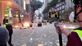 Fires burning on the streets of Wanchai as Water Cannon and riot police approach on China's National Day