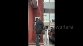 A shocking moment a homeless woman sprays air refresher in her EAR