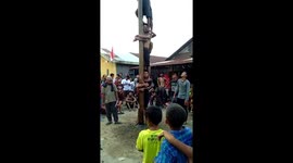 Youngster's Friends Climb All Over Him At Village Fair