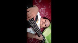 when kids try played a ukulele