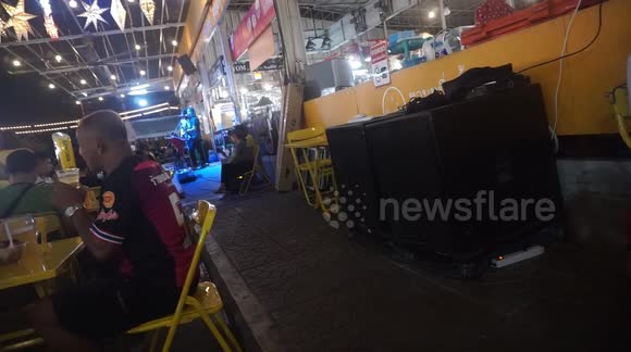 Little Thai girl tries to lip sync and shake a leg to live music