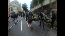 Hong Kong protesters carry tyres and bamboo sticks at protest against mask ban