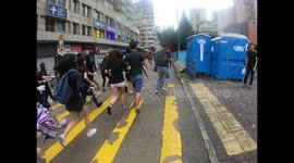 Protesters run as they seek to rejoin their comrades in Sham Shui Po