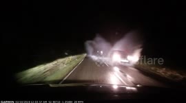 Car windscreen blinded by water splash from passing vehicles on UK road