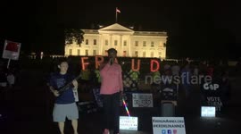 'Fraud' sign held outside White House by student protesters playing music
