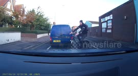 Close call cheeky cycling cutting across car, pulling away at traffic lights Great Yarmouth  UK