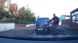 Close call cheeky cycling cutting across car, pulling away at traffic lights Great Yarmouth UK-Zoomed in more version