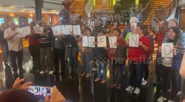 Protestors hold signs “Shame on NCL” “We want Refund”