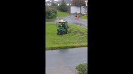 Man operating Galway council mower tears up field cutting on a rainy day