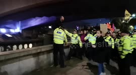 Extinction Rebellion Protestor Trys To Escape The Police By Walking On The Wall next to the River Thames