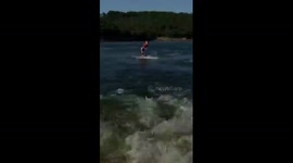 Six-year-old doing wakeboard tricks on lake in Oklahoma