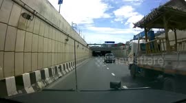 Dangerous moment wooden gazebo topples off the back of speeding truck