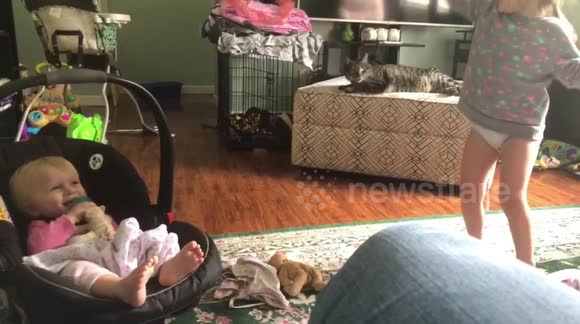 Girl makes baby sister laugh with karate moves