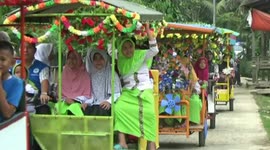 Exorcist in Indonesia leads massive procession of colourful rickshaws in ancient ritual