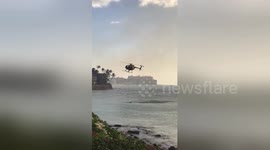 Dramatic moment helicopter collects ocean water to douse fire at Hawaiian airport