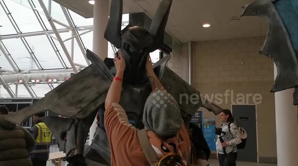 Huge cosplayer enters London Comic Con 2019 with big weapon and helmet
