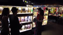 Terrifying selection of masks and dolls on sale at market in Thailand