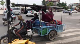 Toddler Chills In Hammock On Parents' Motorcyle Trailer