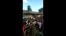 Politician carried by supporters is brought down by a bull on rampage