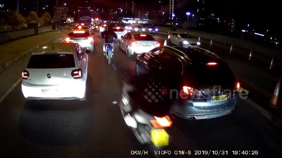 No lights, no helmets, no license plates: Hooded youths on mopeds weave through Manchester traffic on Halloween night, hitting cars