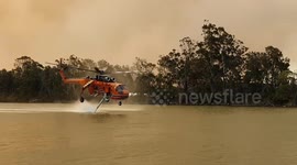 Skycrane helicopter fighting Australia bushfires refills water on the Manning River